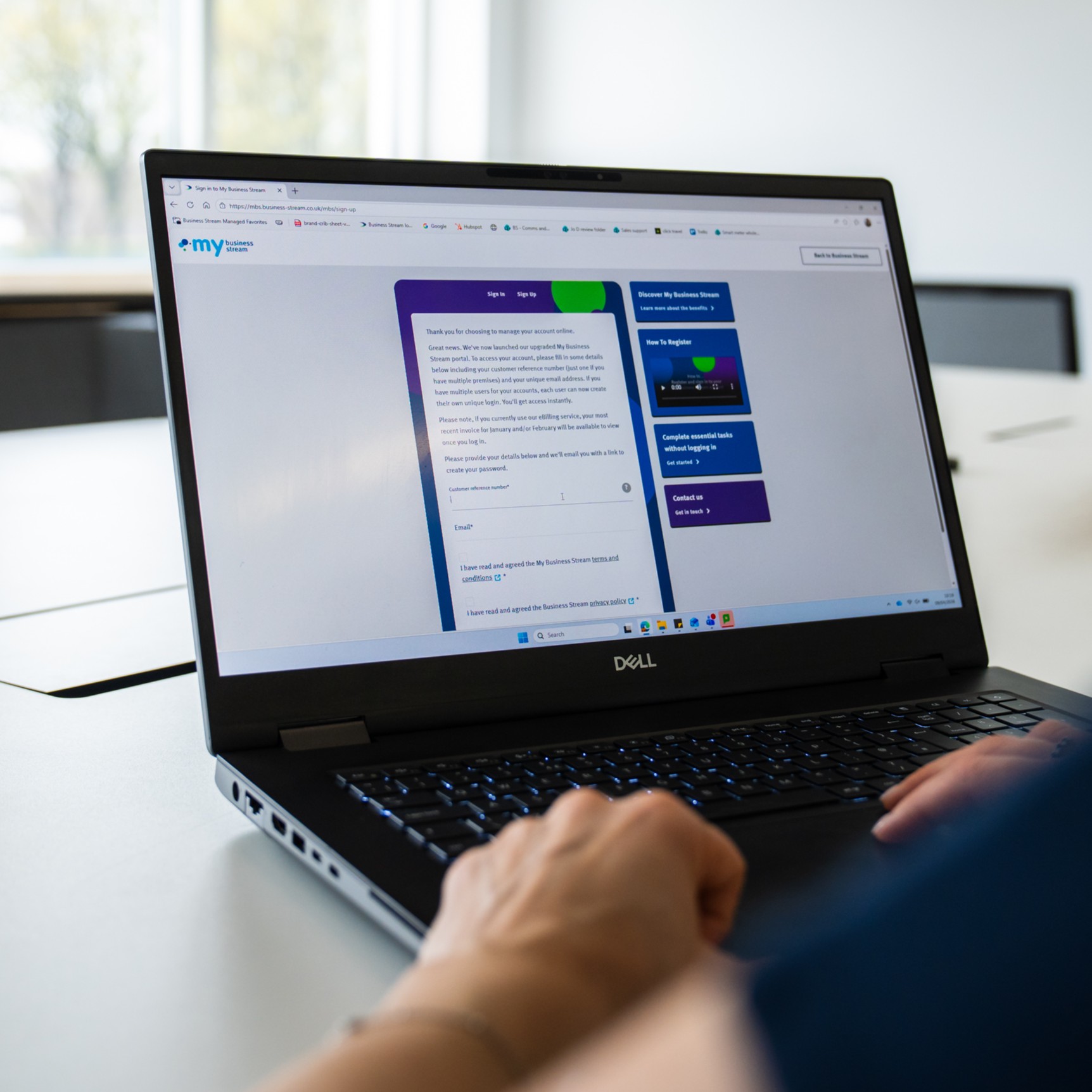 Over-the-shoulder view of laptop showing sign-in screen for My Business Stream