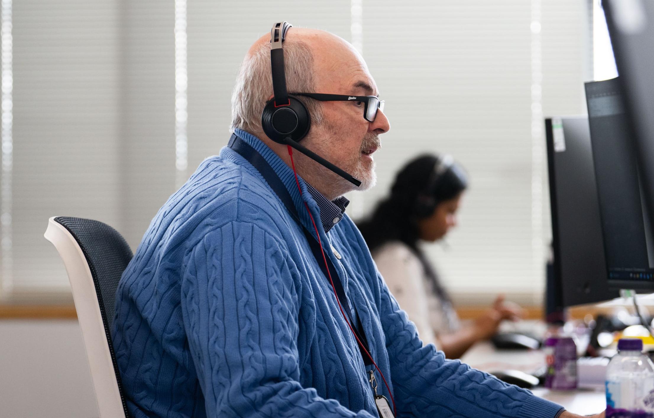 Man wearing headset advising a customer