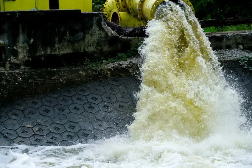 Discoloured effluent gushing from a pipe