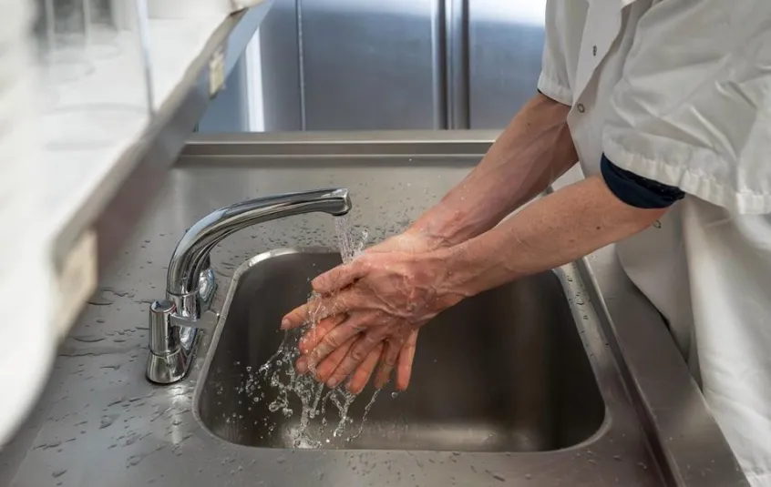 Man washing hands in commercial kitchen