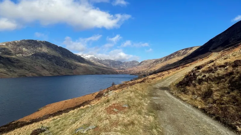 Footpath along the side of a loch with water to left and mountains in background