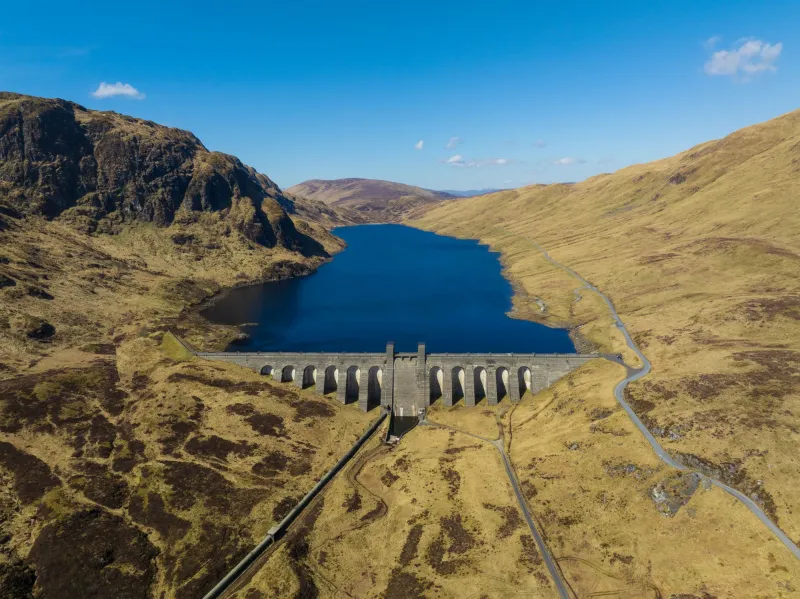 Lochan an Lairige reservoir from high up with blue sky above