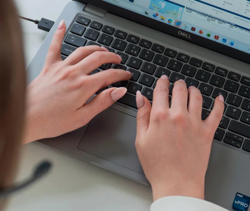 Close-up of female hands on a laptop keyboard