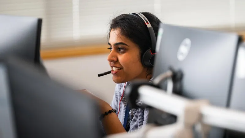 Woman in call centre setting speaking on headset
