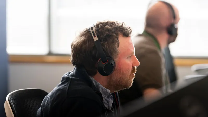 Man wearing headset advising a customer