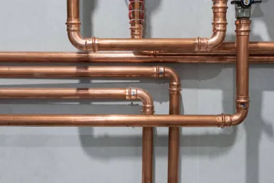 Close-up of copper pipework on grey background