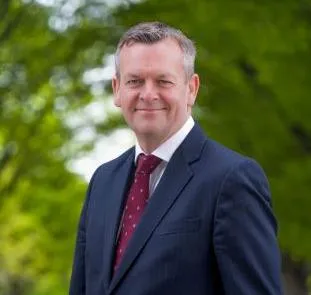 COO Douglas McLaren with trees in background